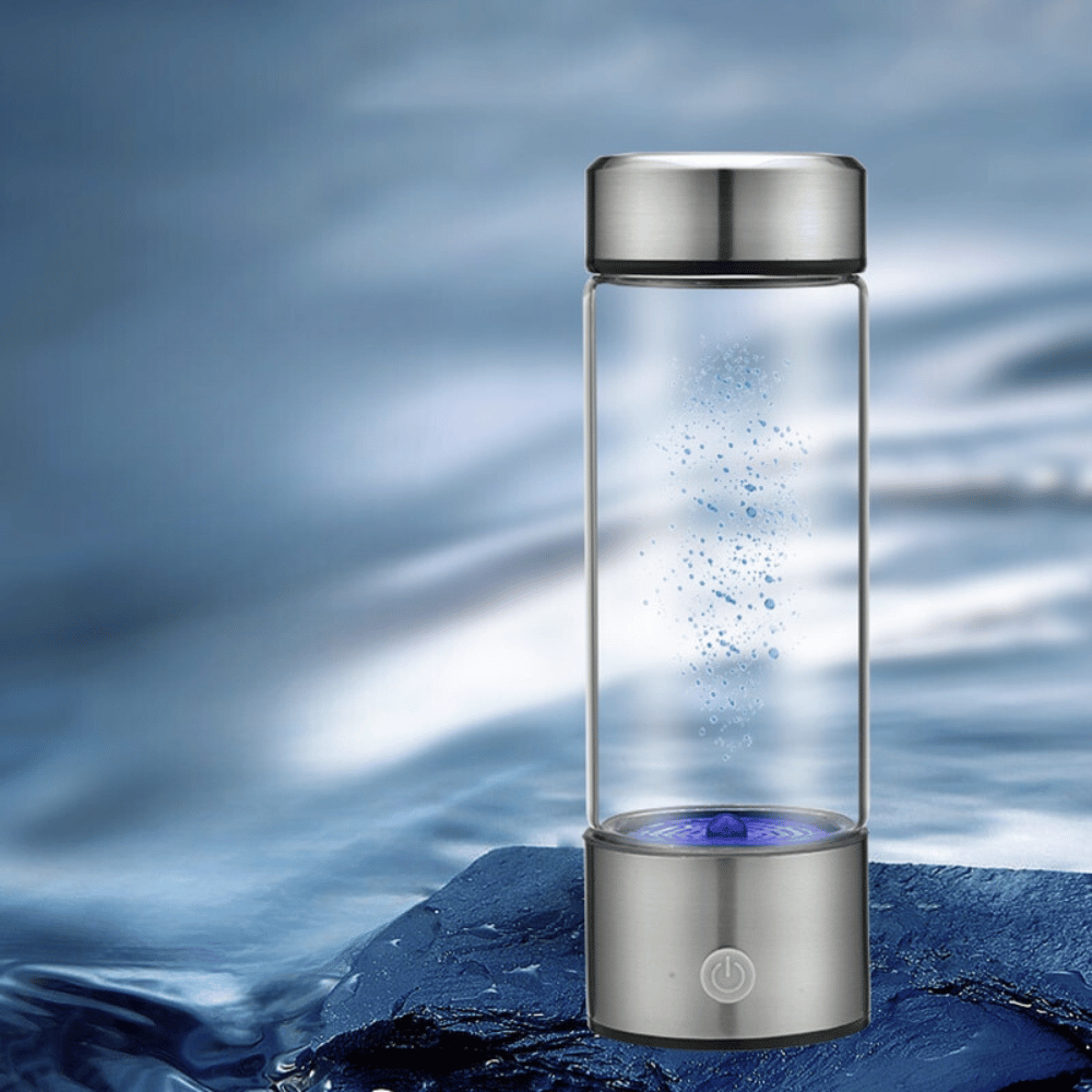 Glass water bottle with silver cap and base on a blue water background