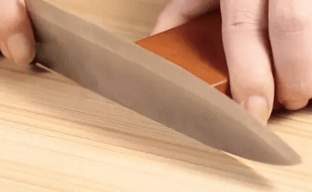 Magnetic Rolling Knife Sharpener with wooden base sharpening knife blade, showcasing durable and elegant construction